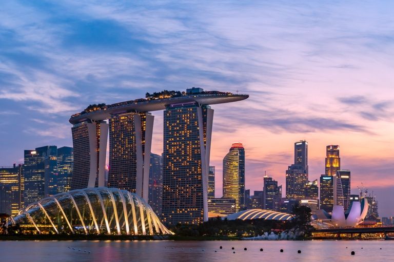 Aerial view of Marina Bay Sands and the Gardens by the Bay skyline in Singapore at dusk