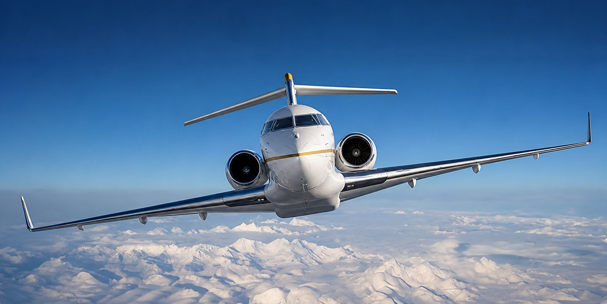 Private jet in flight above snow-capped mountains
