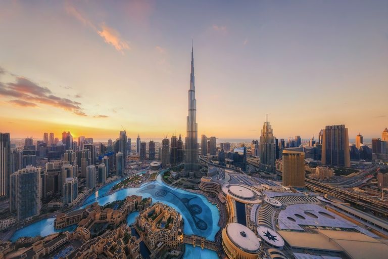 Aerial view of the Burj Khalifa and Dubai Fountain in Downtown Dubai at sunset