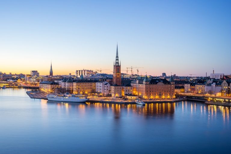 Riddarholmen's waterfront and church spire above Stockholm's harbour at dusk