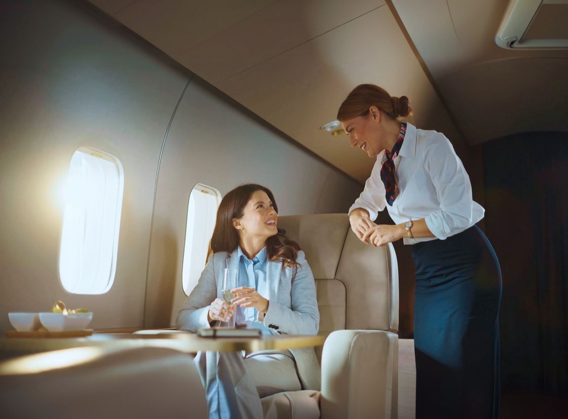 A passenger being served on board a private jet